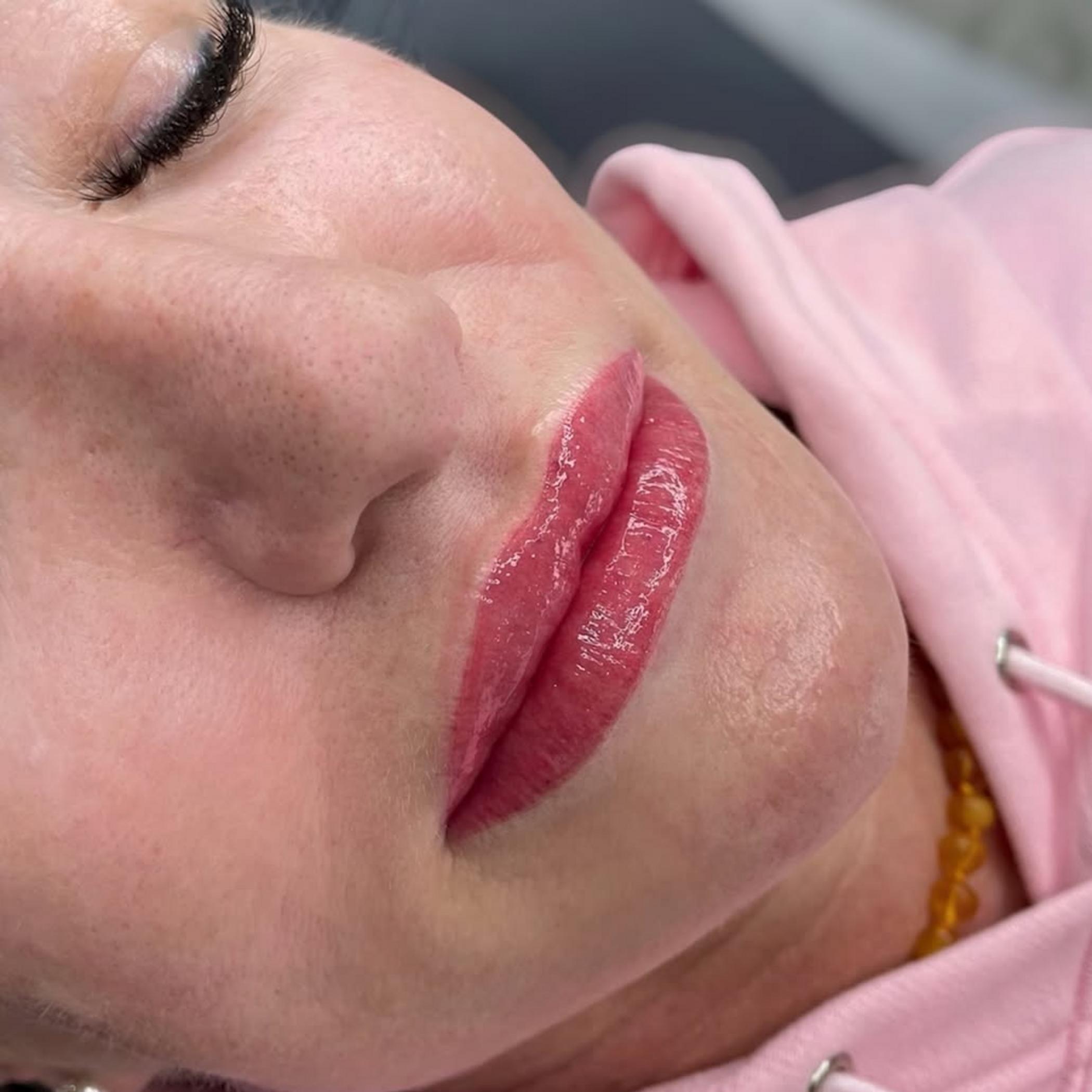 technician applying lip liner tattoo