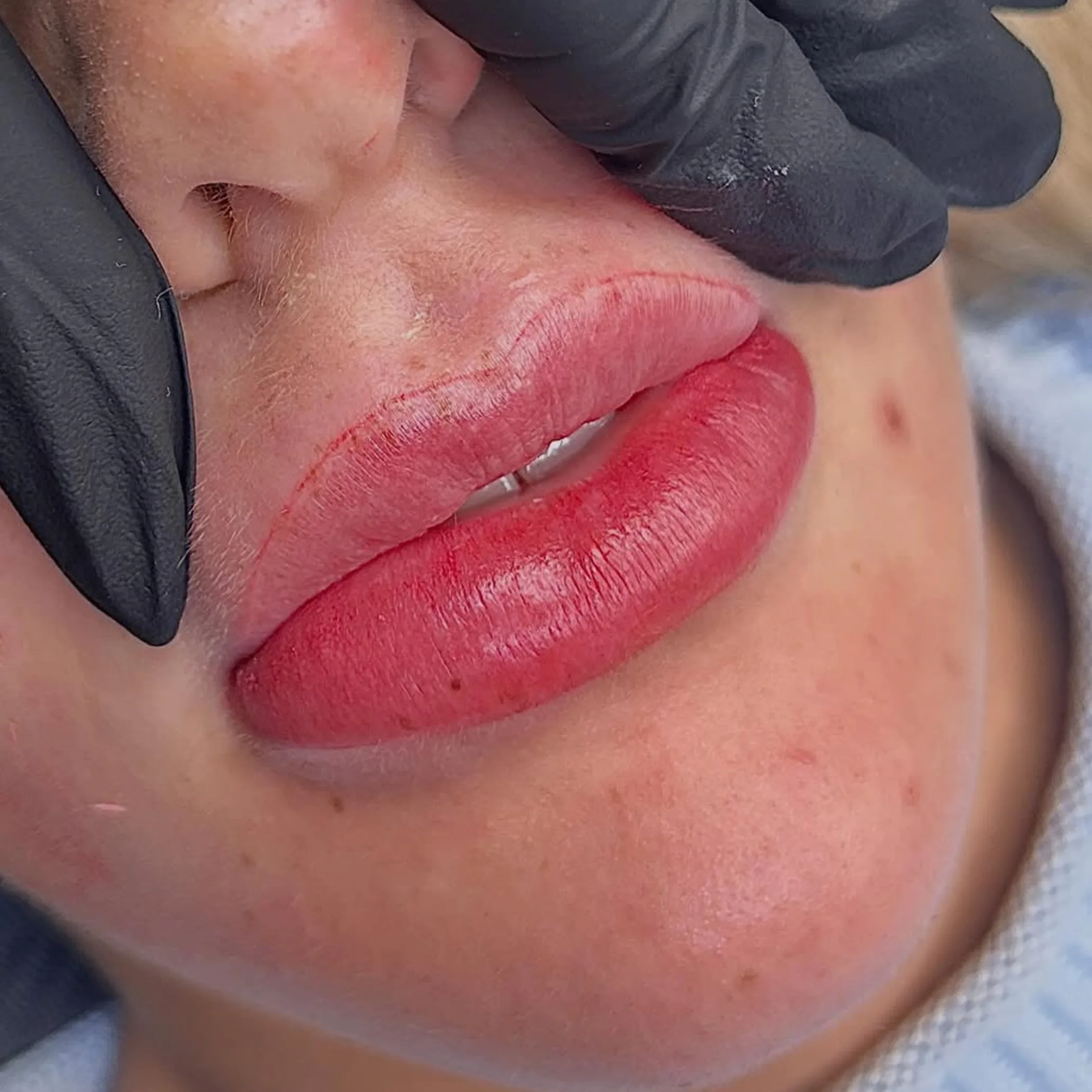 cosmetic tattoo artist mixing warm pigment