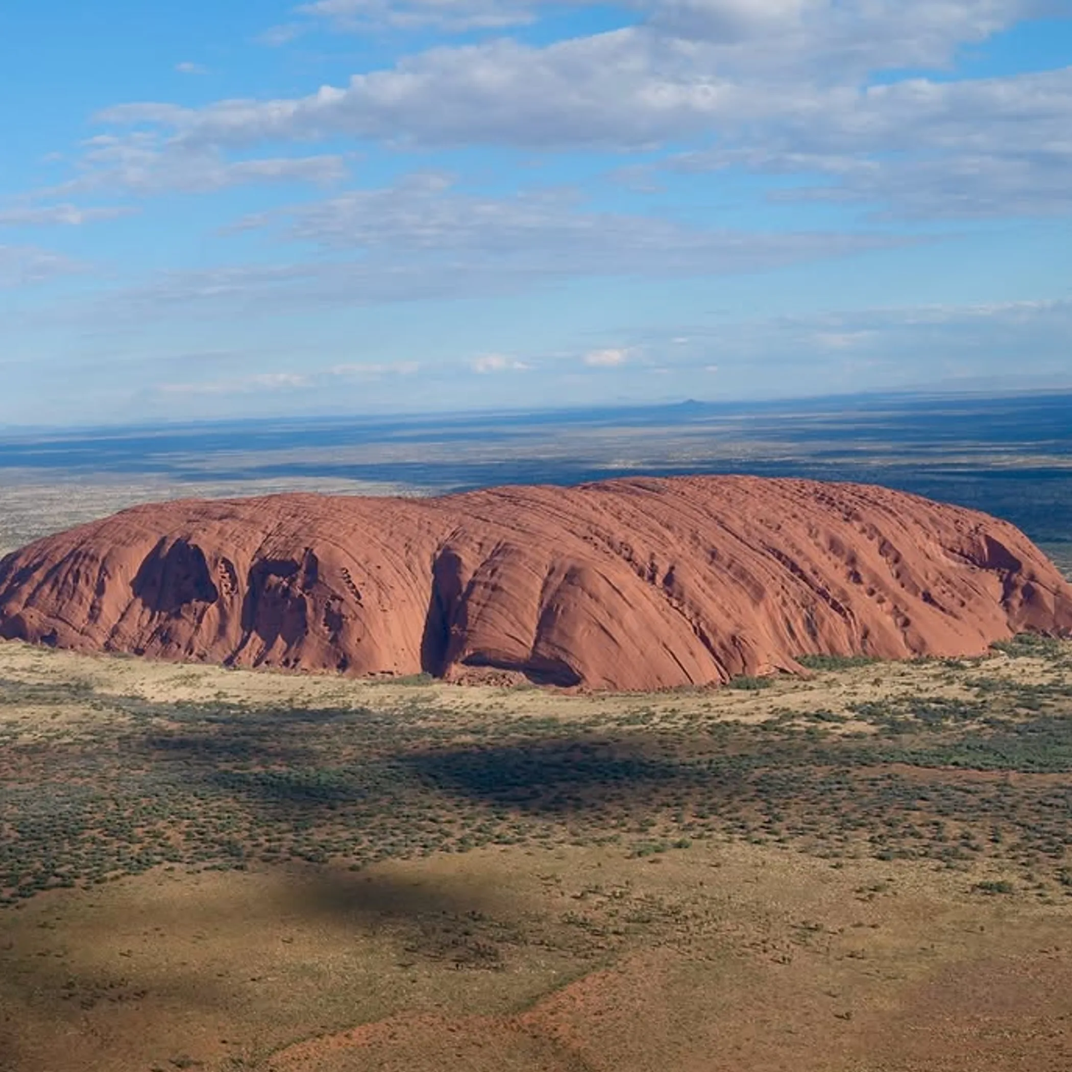 well-lit uluru rock formation