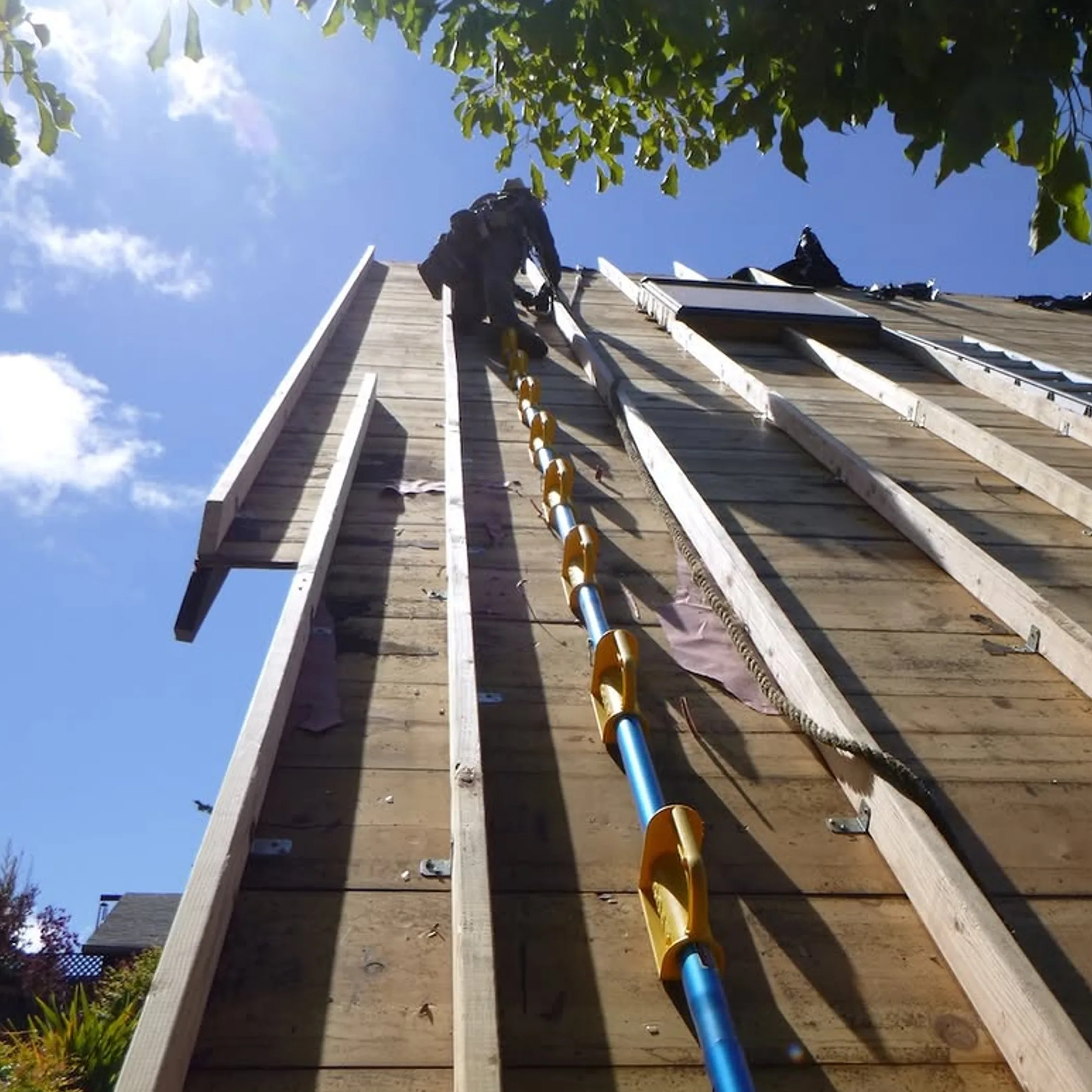 roofer using safety equipment on roof